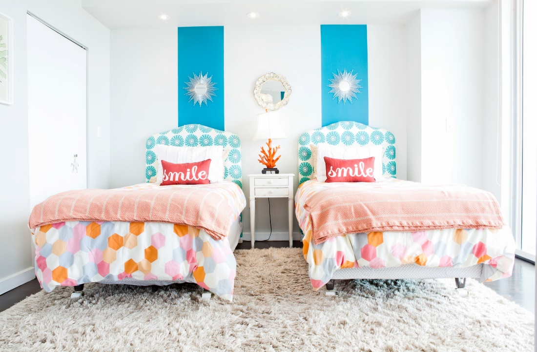 Two beds and colorful bedding in a child’s bedroom